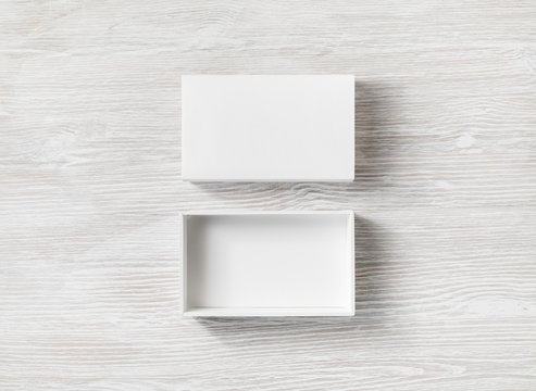 White Cardboard Box With Cover On Light Wooden Background. Flat Lay.