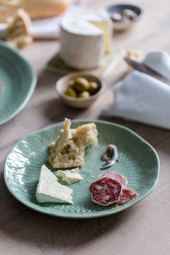A european inspired lunch of baguette, cheese, charcuterie, olives and anchovies.