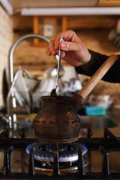 Coffee preparing in old turk on stove