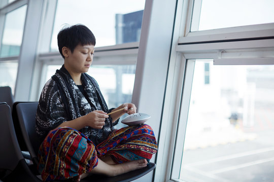 Asian women pounding instruments - 'empty drums' ,in airport, On the journey