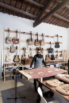 Guitar luthier working in his workshop