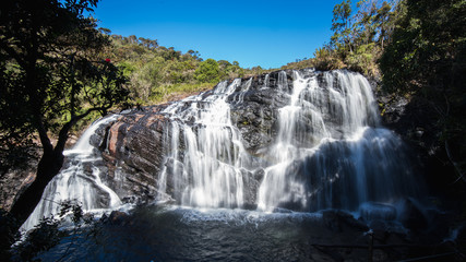 Fototapeta na wymiar small wide waterfall in forest