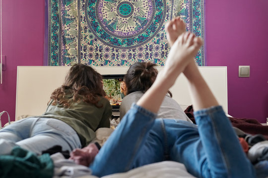 Relaxing women enjoying movie on laptop