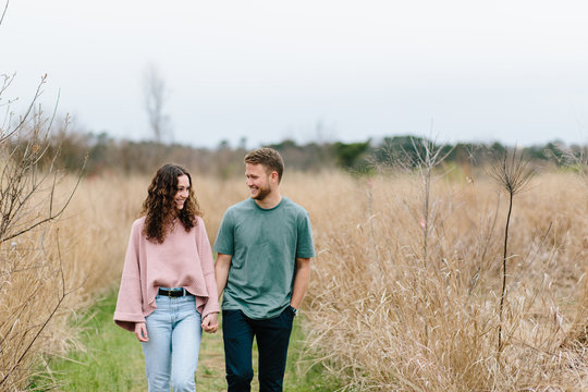 Cute young couple walking in a field