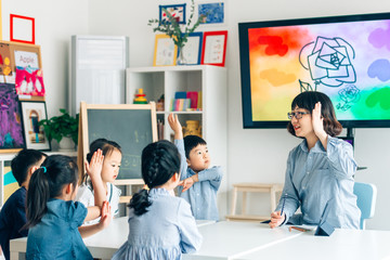 Teacher and preschool kids in classroom