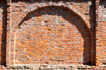 Arch in the old red brick wall