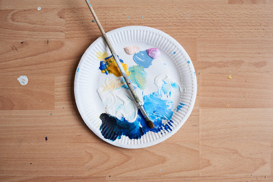 Handmade palette on parket floor with brush.