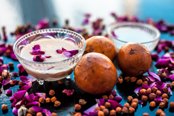 Face pack of sapodilla or chikoo to get back the glow on dull wrinkled skin on wooden surface consisting of Sapodilla pulp well mixed with milk and besan or chickpea flour.