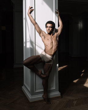 Ballet dancer posing at the column