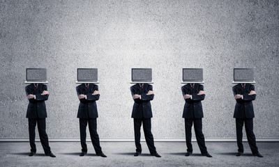 Businessmen with laptops instead of head.