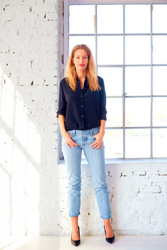 Attractive Middle Aged Woman Full Length Shot While Standing By The Window