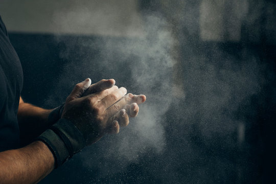 Hands with chalk ready for exercising.