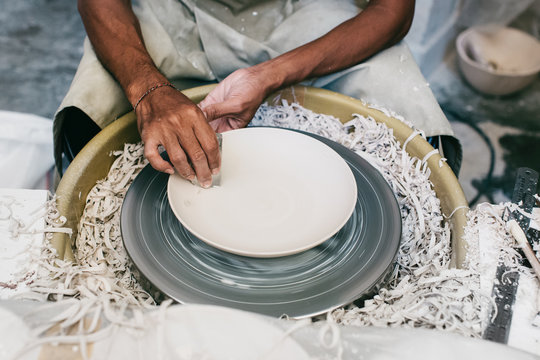 Closeup of Artisan Master Potter Making Plate on Flywheel in Bri