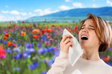 Fototapeta premium Cold woman holding handkerchieif blowing nose