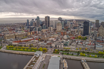 Fototapeta na wymiar Aerial View of the Montreal Skyline and Harbor on a cloudy Day in May