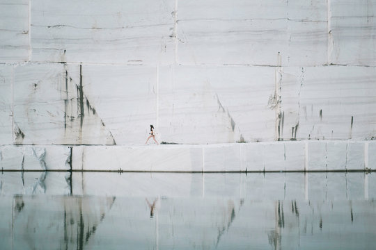 Woman running by the marble lake