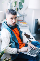 handsome young man using laptop computer with headset