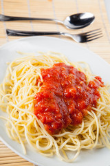 Macaroni with tomato sauce on white background