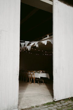 Bunting and table set up for wedding inside old stables