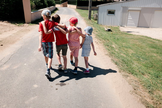 Four Kids Walking With Linked Arms