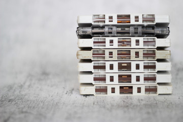 Stacked white cassette tapes on gray background