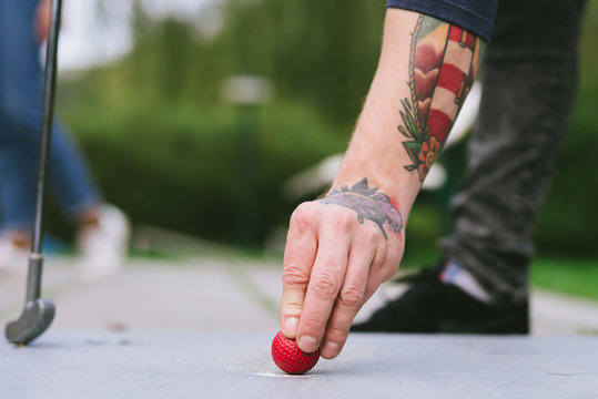 Hand with miniature golf ball
