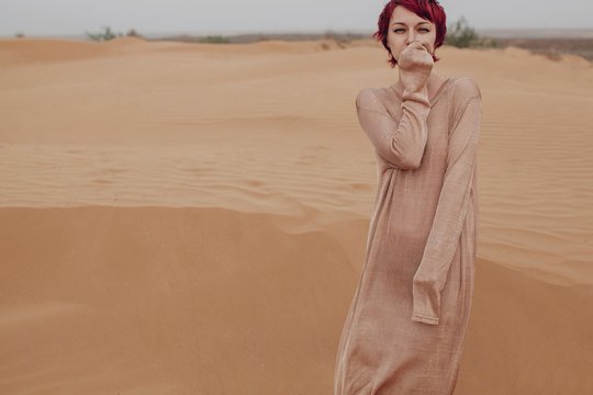 Emotional portrait of woman in desert