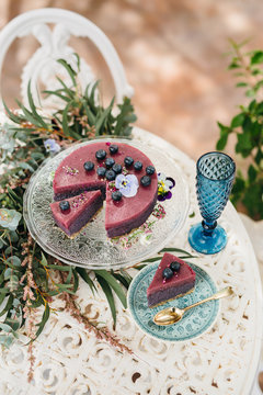 Outdoor iron table with vegan cake