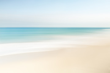 Abstract blurred waves at the beach on a clear day in spring