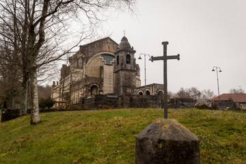 Fototapeta premium Mount Urkiola, Basque Country with Anboto mountain. Church, forest and walkers in the fog. Spain