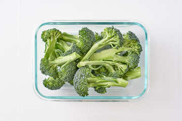 Washed and sliced broccoli crown in glass container