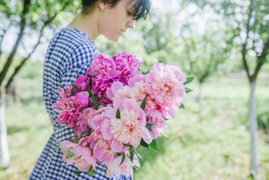 Woman holds peonies