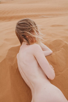 Blonde woman posing nude