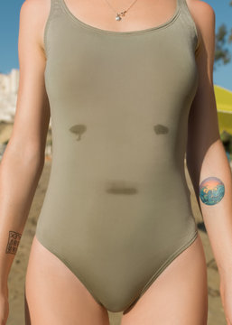 Crop girl in swimuit on beach