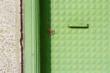 Old and painted green door pattern