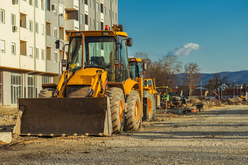 Construction vehicle with loader on building site