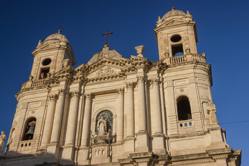 Catania baroque architecture in historic church, beautiful facade in sunny blue sky