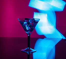 A glass of martini glass with club background