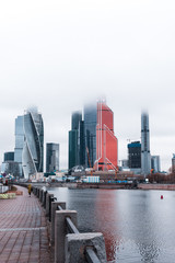 Fototapeta na wymiar Fog-covered skyscrapers of Moskva City (MIBC) next to river Moscva during a moody and misty winter day in Moscow (Moscow, Russia, Europe)
