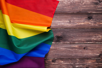 Rainbow flag on brown wooden table