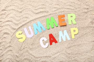 Fototapeta na wymiar Paper text Summer camp on beach sand
