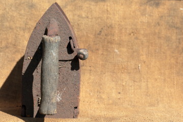 Rare iron working on coals. It stands on a coarse cloth.