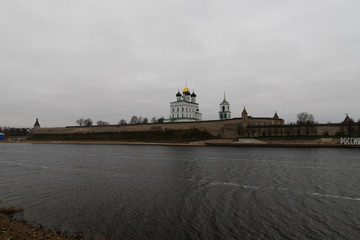 Pskov Kremlin with its picturesque green and golden towers next to Velikaya river as seen during Russian winter (Pskov, Russia, Europe)