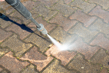 Cleaning concrete block floor by high pressure water jet outdoor