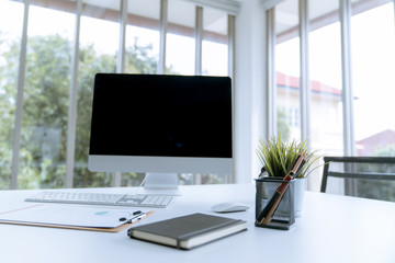 Fototapeta premium Modern white desk work table with computer laptop and stationary in home office