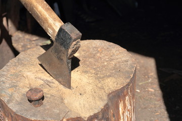 The ax is hammered into a wooden deck.  Next is a hammered anvil for riveting a scythe.