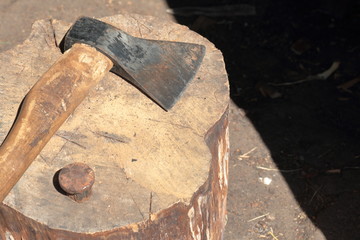 The ax lies on a wooden deck.  Next is a hammered anvil for riveting a scythe.