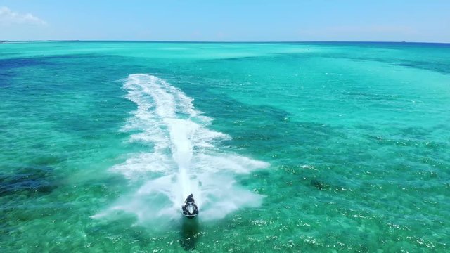 Jet ski Rider Splash Through The Sea At Fortuna Beach, Freeport Bahamas