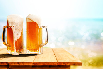 Cold beer in glass on wooden table and free space for your decoration. 