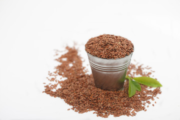 Tin bucket full of  linseeds or flax seeds. Healthy food concept.